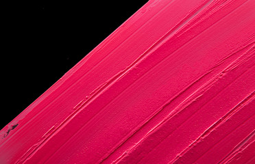 Smudged lipstick pink on a black isolated background