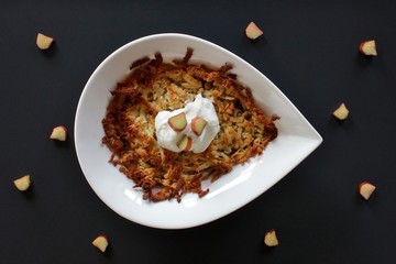 Baked rhubarb crumble with grated marzipan and topped with greek yoghurt and slices of rhubarb

