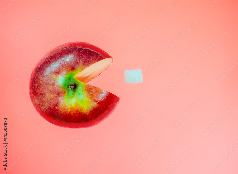 Wall mural creative idea with apple like character computer game pacman on red pastel background. art food conc