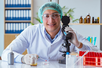 Young doctor working on blood test in lab hospital