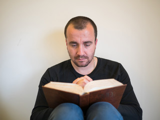 Man reading bible on white background