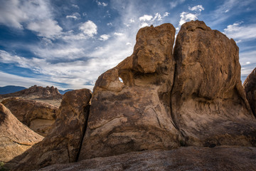 Fototapeta premium Amazing giant rock formations with blue sky and clouds at Alabama Hills, Lone Pine, California