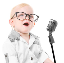 Baby boy with book sitting on white background