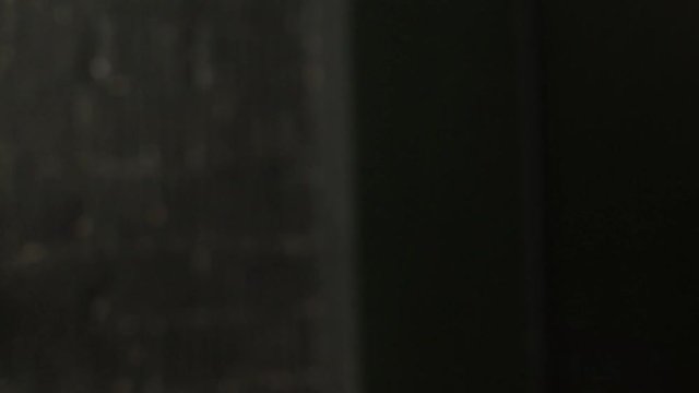 Master hairdresser with a mustach styling hair with spray. Close up