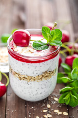 Fresh cherry yogurt with oats and chia seeds, healthy breakfast