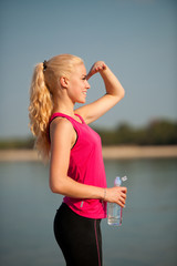 woman rests after morning workout on the beach