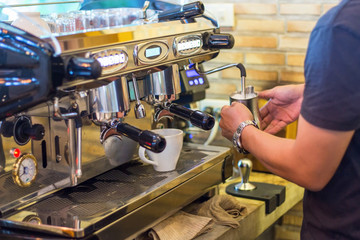 A Man Making coffee in the coffee machine