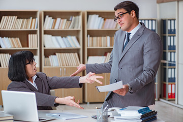 Angry boss reprimanding fellow employee