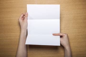 Fototapeta premium woman hand hold a letter with envelope on the wood table.