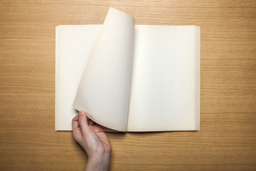 woman hand hold a white note on the wood table(background)