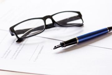 Fototapeta premium businessman office desk with contract for signig, glasses and pen