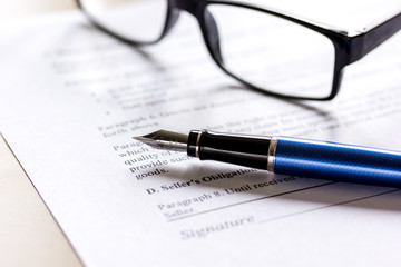 Fototapeta premium office desk with signing contract, glasses and pen for business