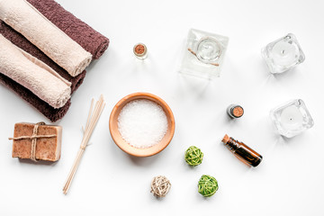 Fototapeta na wymiar spa cosmetics with soap, salt, oil on white background top view