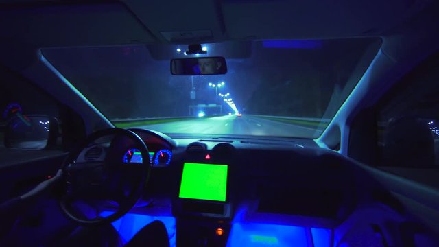The man drive a car on the night autobahn. inside view. wide angle, alpha channel green screen, real time capture