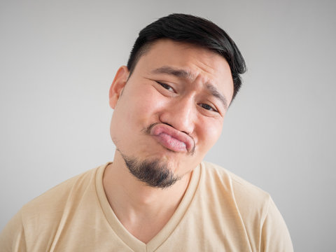 Headshot Of Funny Guilty Asian Man.