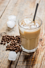 Ice coffee with milk and beans for lunch on stone background