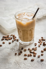 iced coffee with beans for cold summer drink on stone background