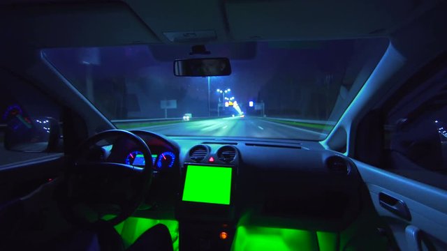 The man drive a car in the autobahn. evening night time. wide angle. green screen display, real time capture