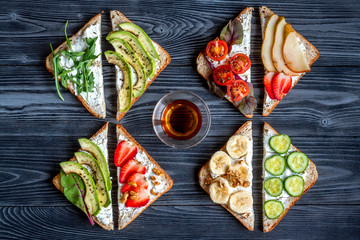 fitness breskfast with homemade sandwiches dark table background top view