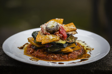 Vegetable stack - pumpkin, zucchini, red capsicum, eggplant and mushroom cooked in a tomato, onion, and garlic sauce topped with parmesan cheese