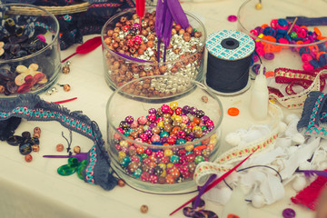 Decorate tools fabric ,bead ,small bell and feather for DIY behemian vintage style. Selective focus