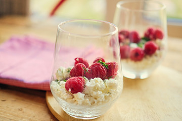 Diet curd with raspberry on a plate.