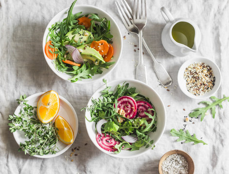 Rocket , Beets, Avocados, Carrots, Seeds, Nuts Detox Salad With Orange Dressing On A Light Background, Top View. Vegetarian Healthy Eating Concept