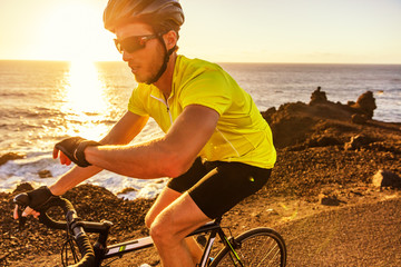 Cyclist biking looking at smartwatch while riding road bike. Athlete biker using activity tracker...