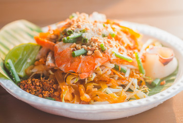 The traditional Thai food Pad Thai Noodles with shrimp and vegetables on foam dish