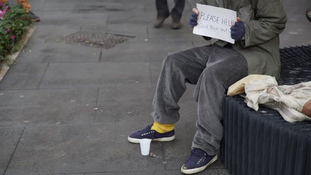 portrait of Elderly man offers a croissant and a hot coffee to a homeless