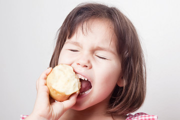 Girl biting an apple 