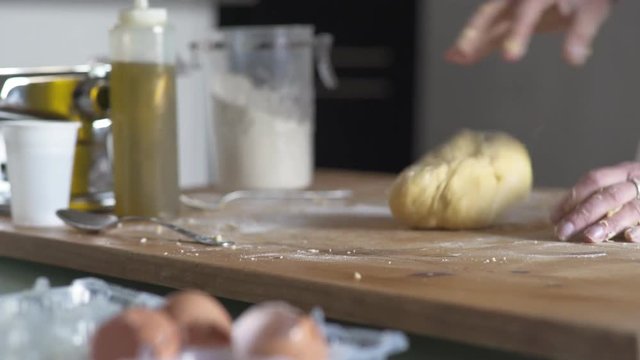 Woman hand bake the dough on wooden chopping board