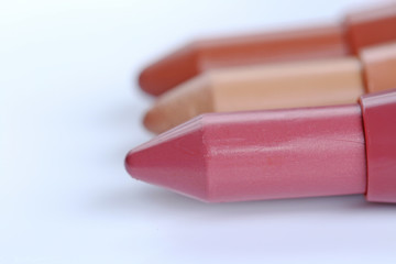 lipstick pencil in a row on a white background