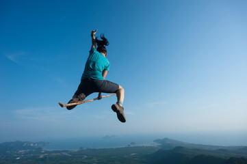 Fototapeta na wymiar jumping on rocky mountain peak, freedom, risk, challenge, success concept