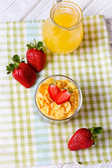healthy breakfast with cereal flakes, strawberry, orange juice