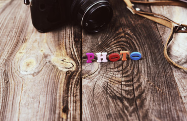 Old vintage camera on a gray wooden surface