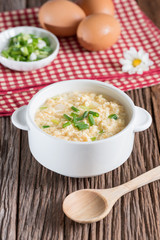 Egg drop soup in white bowl.