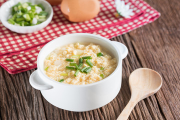 Egg drop soup in white bowl.