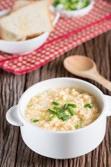 Egg drop soup in white bowl.