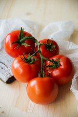 Ripe natural tomatoes growing on a branch in a greenhouse. Shallow depth of field