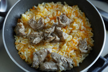 Mediterranean risotto with meat on a fry pan
