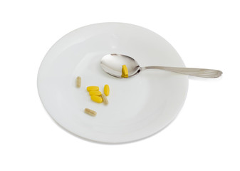 Different dietary supplements on the white dish with spoon