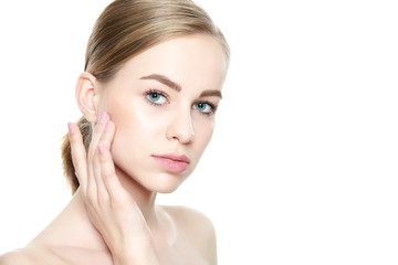 Beautiful Young Blond Woman with Perfect Skin touching her face. Facial treatment. Cosmetology, beauty and spa concept. Isolated on white background.