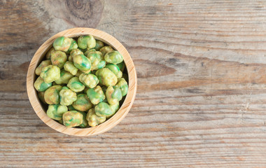 Crispy green peas in wood cup. Top view.