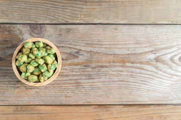 Crispy green peas in wood cup. Top view.
