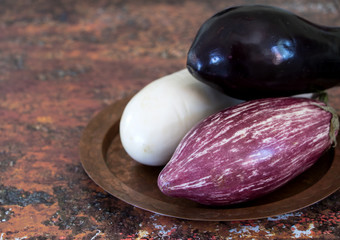bunte Auberginen auf Kupferteller