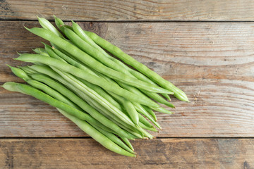 Green bean on wood background. Top view.