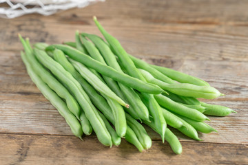  Green bean on wood background.