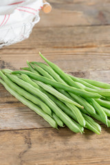 Green bean on wood background.