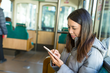 Woman using cellphone in japanese train